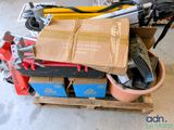 a pile of boxes and tools on a pallet in a garage