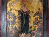 an old wooden icon with a painting of a woman holding a cross