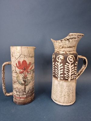 two vases sitting next to each other on a table