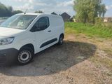 a white van that is parked on the side of the road