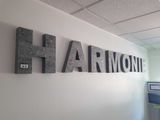 a sign that says harmony hanging on the wall