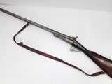 an old gun with a wooden handle and a leather sling