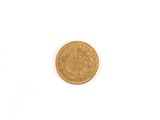 a close up of a gold coin on a white surface