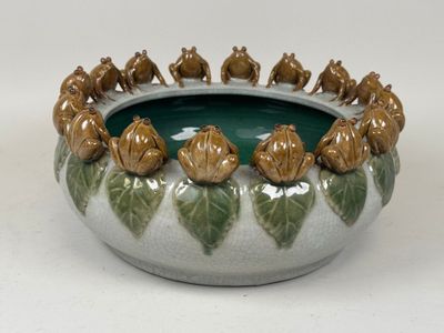 a green and white bowl with a bunch of animals in it