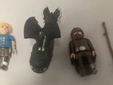 three toy figures that are sitting on a table