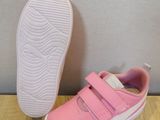 pink shoes with white soles on a wooden surface