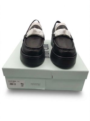 pair of black and white shoes sitting on top of a white box