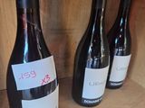 several bottles of wine are lined up on a shelf in a wine shop