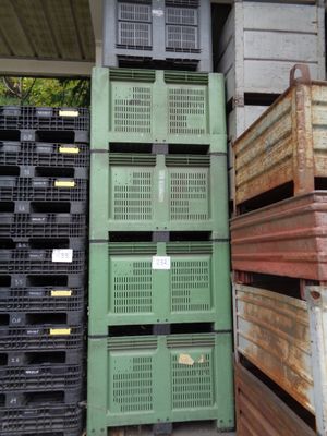 many crates stacked on top of each other in a warehouse