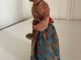 figurine of a woman in a blue dress holding a bell
