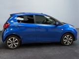 a picture of a small blue car parked in a garage