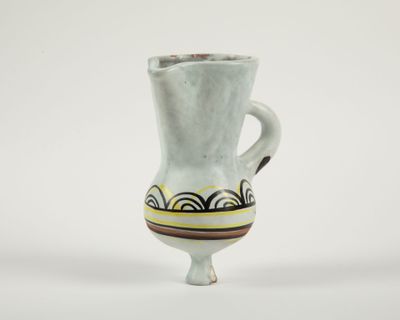 a white vase with a brown and yellow design on it