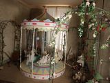 a carousel in the middle of a room with lots of flowers