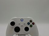 the controller is white and has four buttons on each side of it
