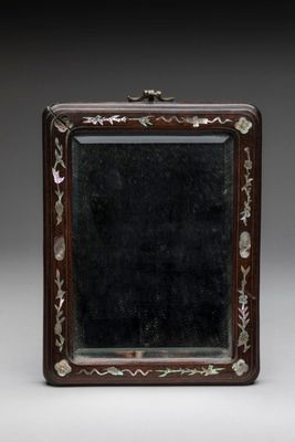 an old wooden box with a mirror on top of it