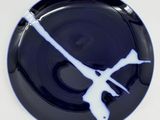 a black and white plate with a blue design on it