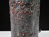 a vase that is sitting on a table with a black background