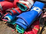 a pile of bags and bags sitting on the ground next to a car