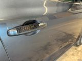 a close up of a car door handle with a sticker on it