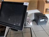 a laptop and printer sitting on a counter in a restaurant