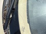 a broken windshield of a car that has been left on the street