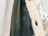 a woman in a white and blue dress with a fur coat