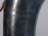 a close up of a silver vase on a table
