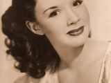 an old black and white photo of a woman in a dress