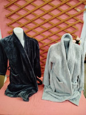 two robes on display on a table in a store