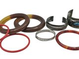 many different colored rings and bracelets on a white surface
