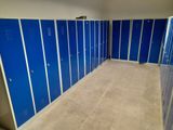 several blue lockers are lined up in a row in a room