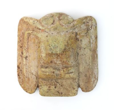 a close up of a stone object on a white surface