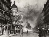 a black and white photo of a fire in a city
