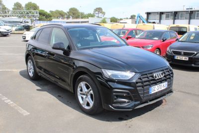the black audi suv is parked in a parking lot with other cars