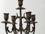 a bronze candelab with five candles on it