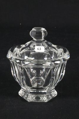 a clear glass bowl with a lid sitting on a black surface