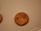 three coins sitting on top of a table next to each other