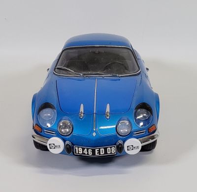a blue toy car that is sitting on a white surface