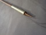 a metal stick that is laying on a table