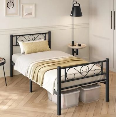 a bed with a metal frame in a room with white walls