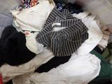 a pile of clothes that is sitting in a basket