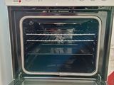a white oven with a glass door in a kitchen