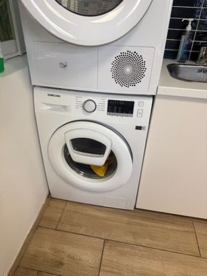 a washer and dryer in the corner of a kitchen