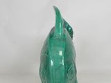 a green ceramic fish head on a white background