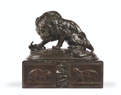 bronze statue of a lion on a pedestal with a bird in its mouth