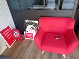 a red chair sitting next to a red sign and a red fire hydrant