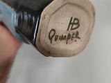 a close up of a person ' s hand holding a bottle of wine