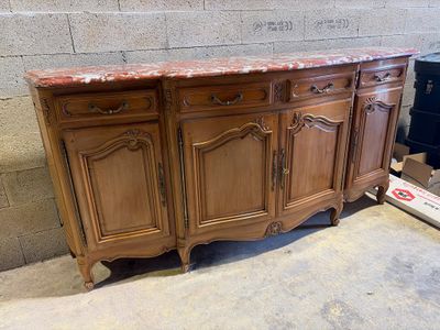 a large wooden cabinet that has a marble top on it