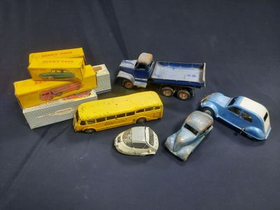 several toy cars and trucks are lined up on a black surface