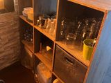 a shelf with dishes and glasses on it in the kitchen